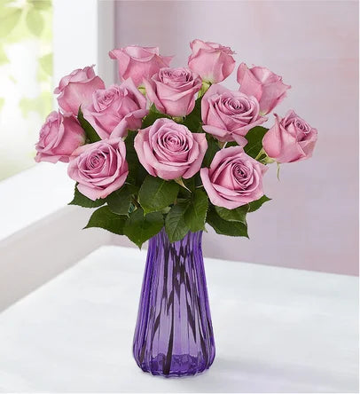 12 long stem lavender roses in a lavender vase