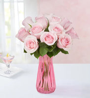 12 long stem pink roses in a pink glass vase